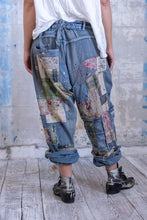 Load image into Gallery viewer, Very baggy jeans with a lot of patches back view 
