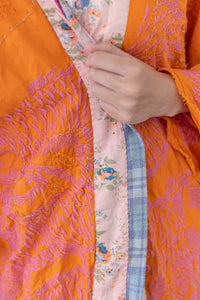 Very up close view of pink embroidery on orange kimono
