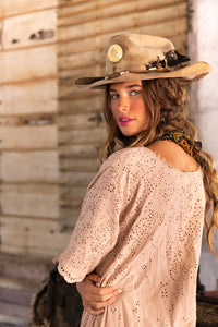 Girl, looking over her shoulder with pink dress and hat