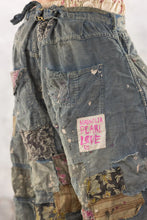 Load image into Gallery viewer, Back view up close of patchwork pants with Magnolia Pearl badge
