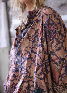 Up close view of left shoulder prairie shirt. Floral pattern.