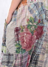 Load image into Gallery viewer, Up close view of plaid overalls with floral appliqué
